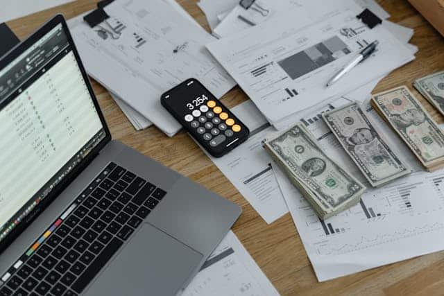 cash and calculator with laptop