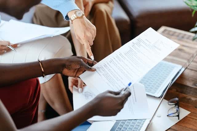 a group of people looking at documents