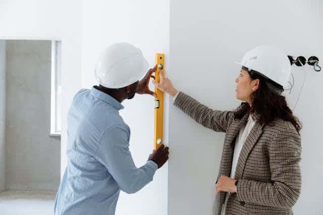 people inspecting wall
